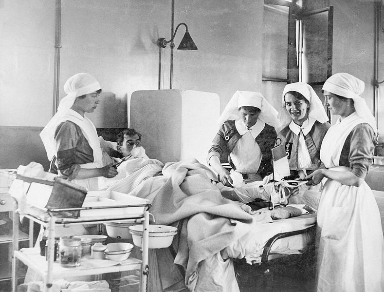 historical photo of nurses treating a patient