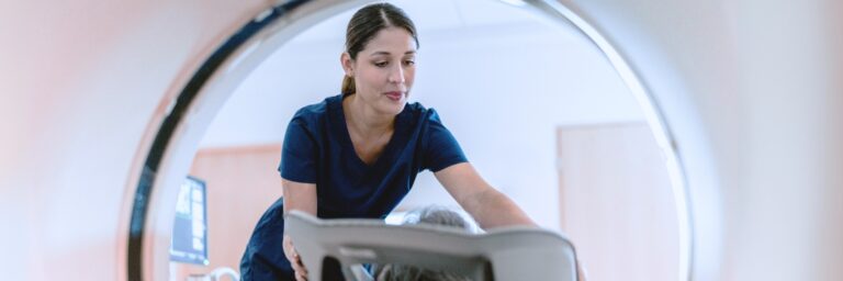 A medical technologist performs a scan using specialized equipment